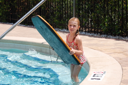 Katie practicing with a boogie board