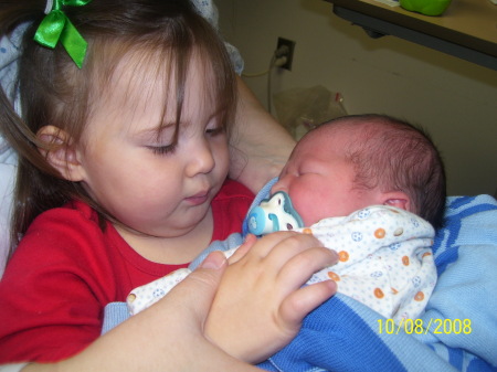 Trinity holding her new baby brother.
