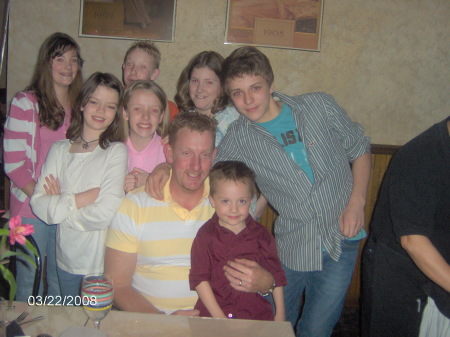 Tom surrounded by kids at his party!