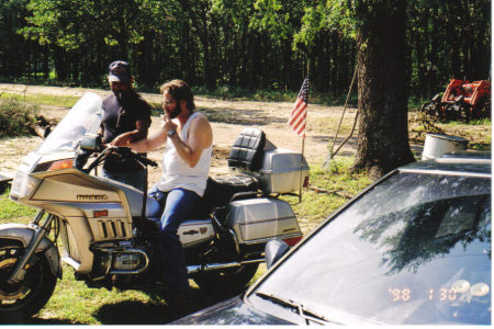 Dell on motorcycle at the property