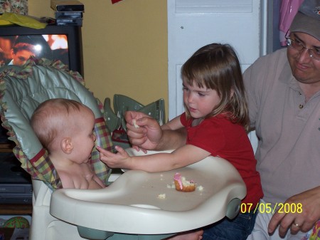 Becca trying to feed Megan some yummy cake!!