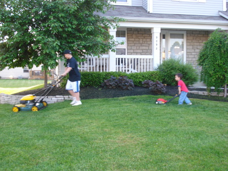 Big Brother showing Little Brother how to mow