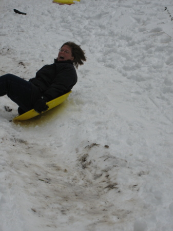 My wife Jackie going for it on a snow disk.