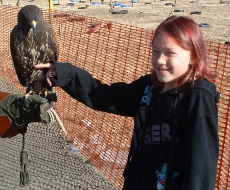 Alisha petting a hawk