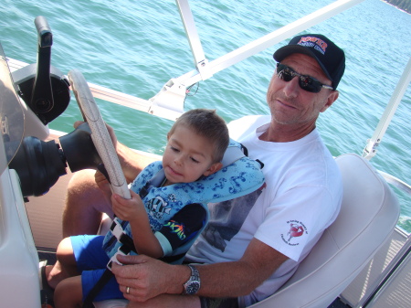 Brice helping Papa drive the boat