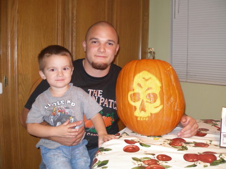 Tanner and Daddy carving the pumpkin 10/08