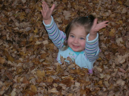 Olivia having fun in the leaves.