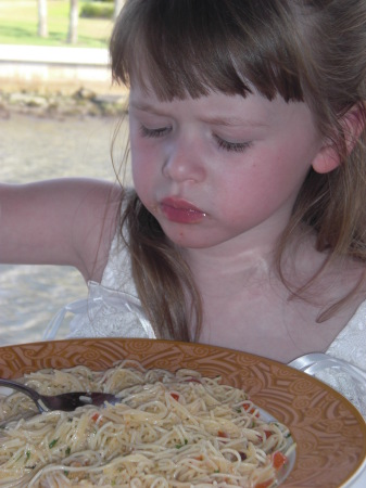 Concentrating on her pasta