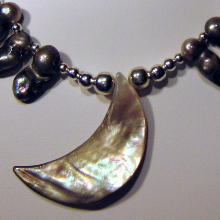 a closeup of the moon necklace