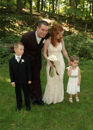 bride and groom with ring & flower officials