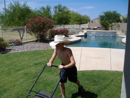 Tanner mowing the backyard grass