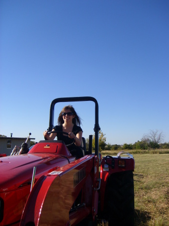 Daughter Chelsea on our tractor