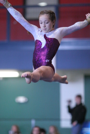 Tana-split leg leep on the balance beam.