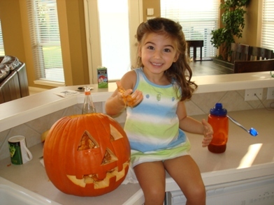 Sienna cleaning out a pumpkin