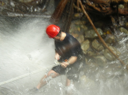 Carlos repelling down the waterfall