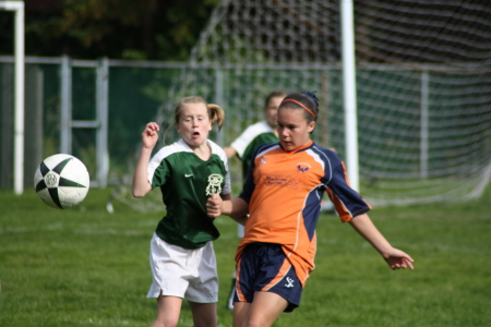 Daughter in orange playing soccer