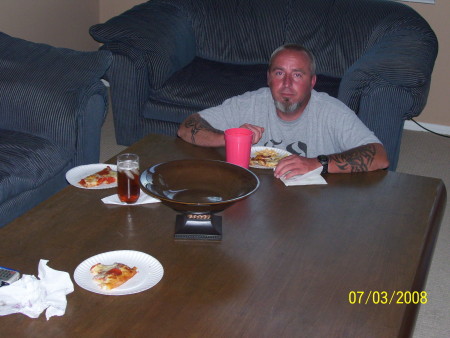 Me eating pizza at my massive coffee table