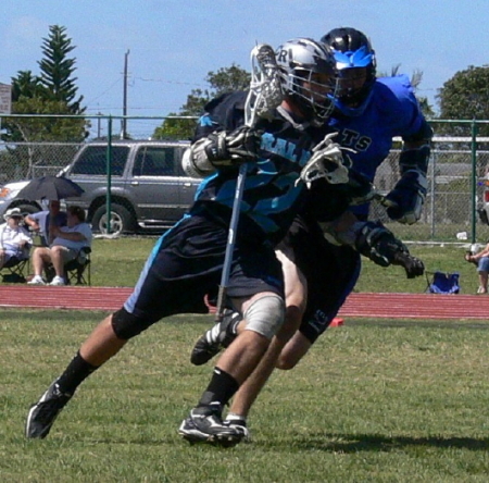 Joseph playing lacrosse for Coral Reef HS