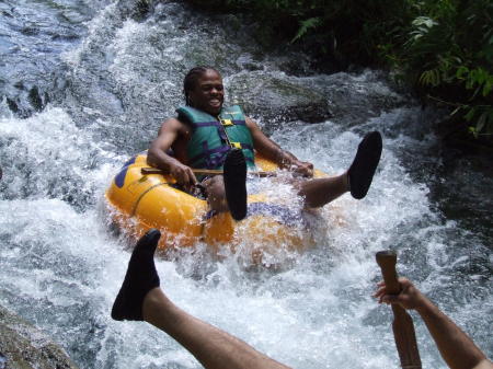 Son cruising down the fast Jamaican river