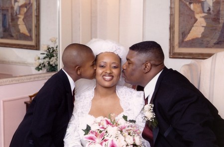 jr groomsman, groom kissing bride