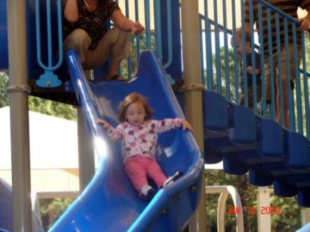 Ana coming down the slide at Wall Springs Park