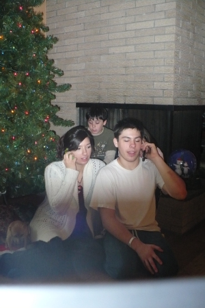 kids on phones, instead of decorating the tree