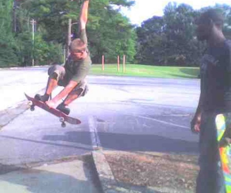My 16 year old son on his skate board, doing a
