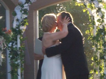 THE BRIDE KISSES THE GROOM
