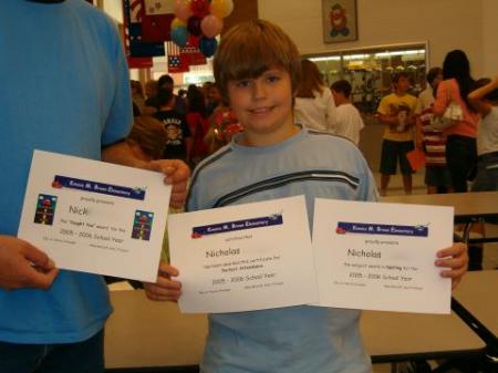 Nicholas showing all of his academic awards.