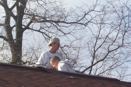 Fixing the shingles blown off the garage roof