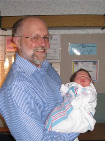 Grandpa holding Emma 1 day old