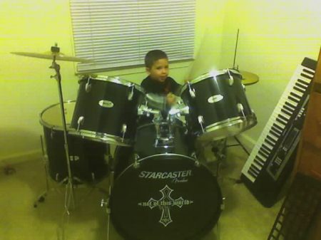 My son on his new drum set