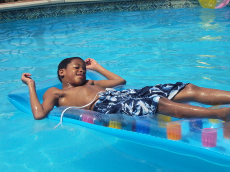 Austin chillin in the pool on hot summer day