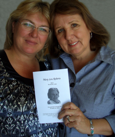 Sue and Judy holding moms memorial