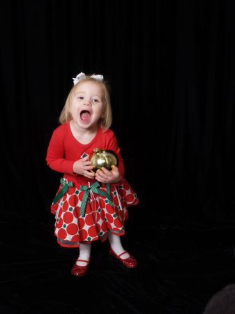 Lexie, screaming, with Cheerios in her mouth