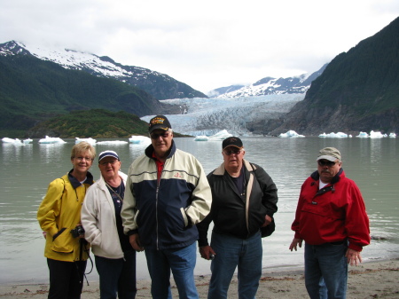 Family in Alaska in front of a glacier..