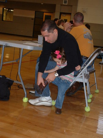 My oldest, Alex, ties his daughter's shoe