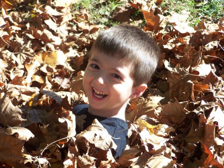 Connor playing in the Fall Leaves