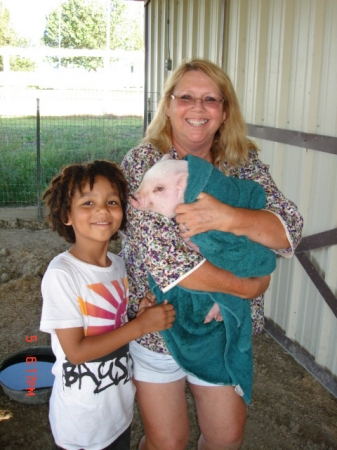 Our Grandson, Iain, with me and new pig.