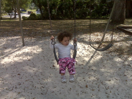 jordan on the swings all by herself