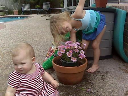 Girls  helping Mimi plant flowers