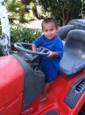 Noah riding Daddy's tractor