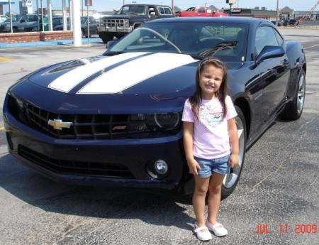 My grandaughter with my new car