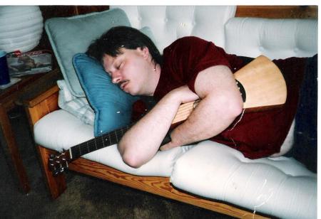 outer banks asleep with back packer guitar