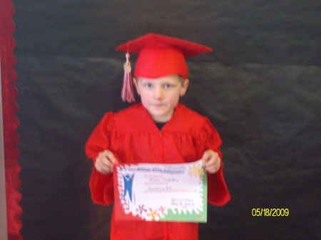 Jason with Diploma, in cap & Gown