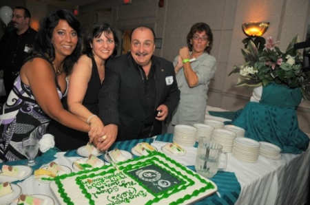 Pat, Val, Joe cutting cake