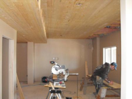 Basement finishing shows knotty pine ceiling