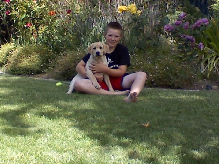 My son, at age 10, with neighbor's new puppy