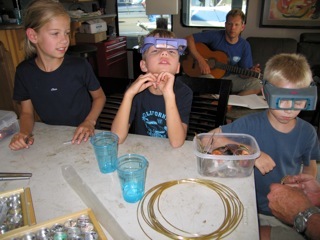 Emily, Justus and Henry making jewelry