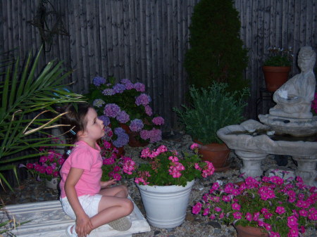 my daughter in her flower garden